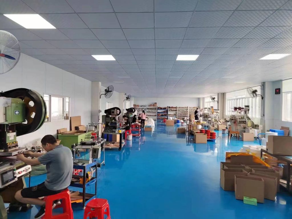 A high-precision die-cutting cleanroom workshop featuring advanced cutting machines, organized workstations, and a dust-free production environment. The facility specializes in manufacturing precision-cut components for electronics, automotive, medical, and industrial applications.