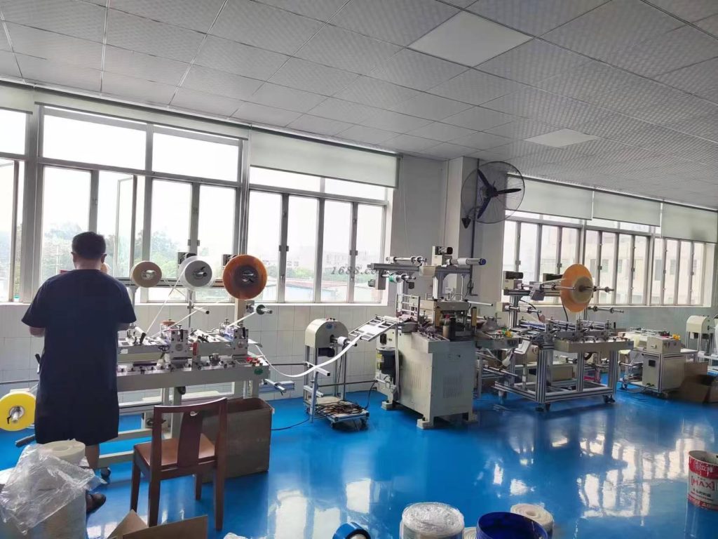 A high-precision die-cutting cleanroom workshop featuring advanced cutting machines, organized workstations, and a dust-free production environment. The facility specializes in manufacturing precision-cut components for electronics, automotive, medical, and industrial applications.